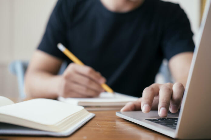 Closeup man hands using computer laptop for online learning, online business, chatting, social media.