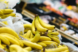 Yellow bananas on the counter. Department in a store or supermarket with fresh products. Selective focus.