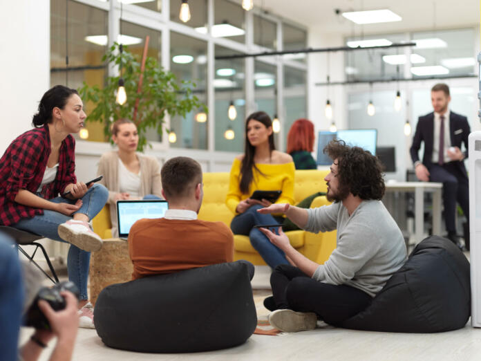 business people group in modern office have a team meeting and brainstorming while working on tablet or laptop presenting ideas and take notes