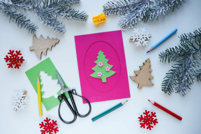 making greeting cards for christmas and new year. Children's DIY concept. Handmade crafts on holiday