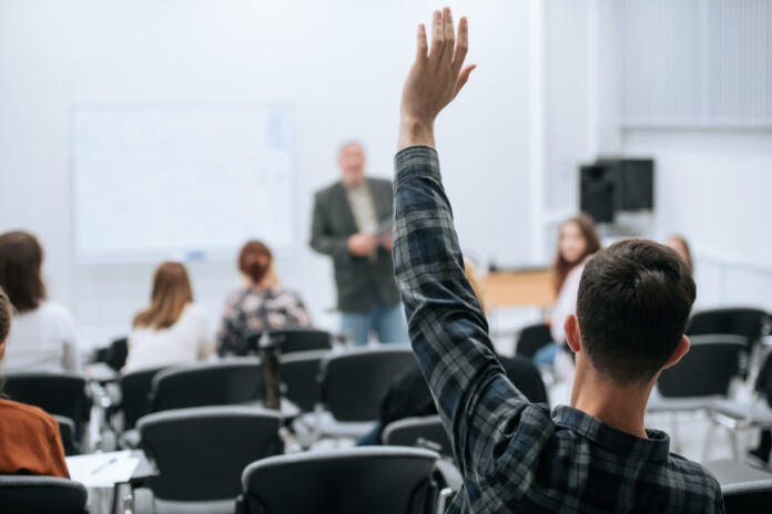 A famous professor has arrived at the university to conduct a special lesson, the student pulls his hand up to ask him a question.