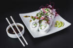 Nikkei Ceviche Roll on a dark table