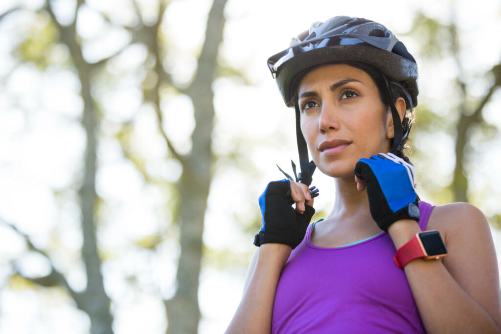 Female athletic wearing bicycle helmet in countryside
