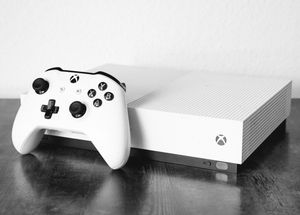 Illingen, Germany – June 01, 2023: A grayscale shot of an Xbox One S on the table