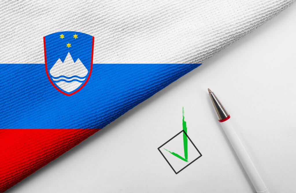 pencil, flag of Slovenia and check mark on paper sheet