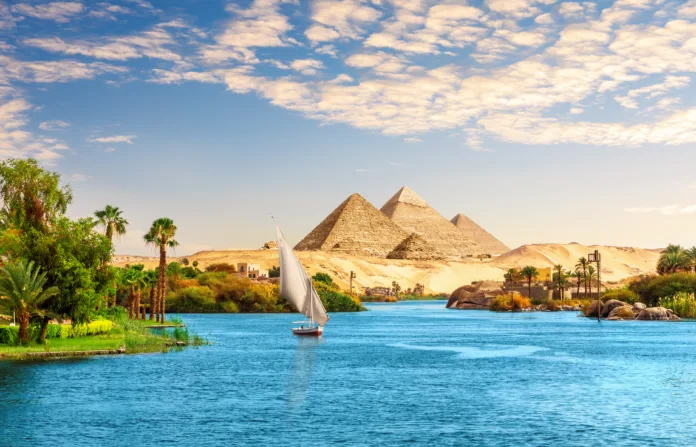 Beautiful Nile scenery  with sailboat in the Nile on the way to pyramids, Aswan, Egypt.