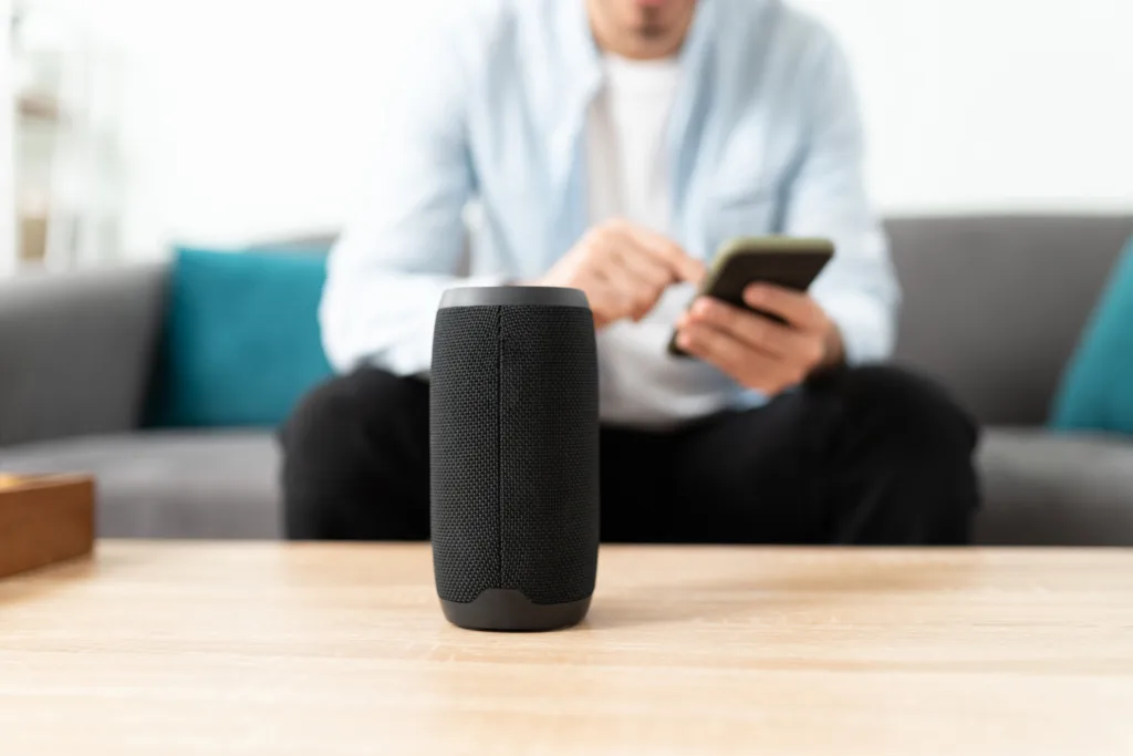 Closeup of a man connecting his smartphone and bluetooth speaker to his smart home system