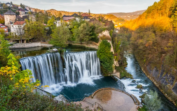 Jajce  town and waterfall in Bosnia and Herzegovina, Europe. Beautiful Pliva waterfall under the old town city in the autumn evening.