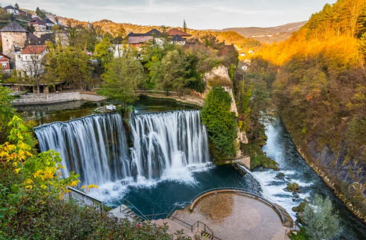 Jajce  town and waterfall in Bosnia and Herzegovina, Europe. Beautiful Pliva waterfall under the old town city in the autumn evening.