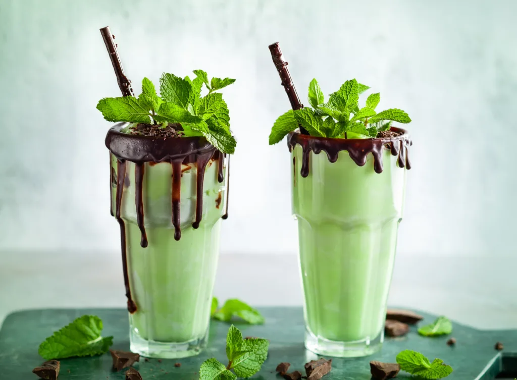 Mint chocolate milkshake with ice cream and fresh mint leaves in glass
