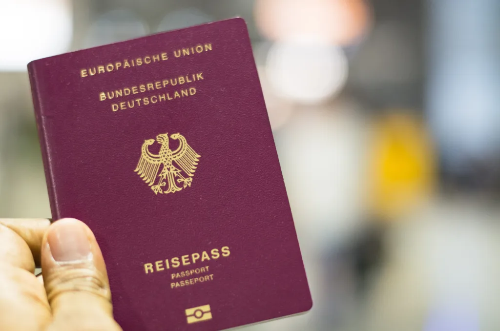 Munich, Germany - September 29 2019: Passenger holding German passport at the airport in Munich, Germany