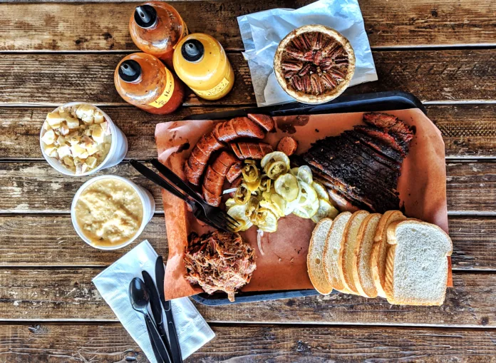 Top down view of Texas-style steakhouse lunch with sausages, pulled pork and brisket