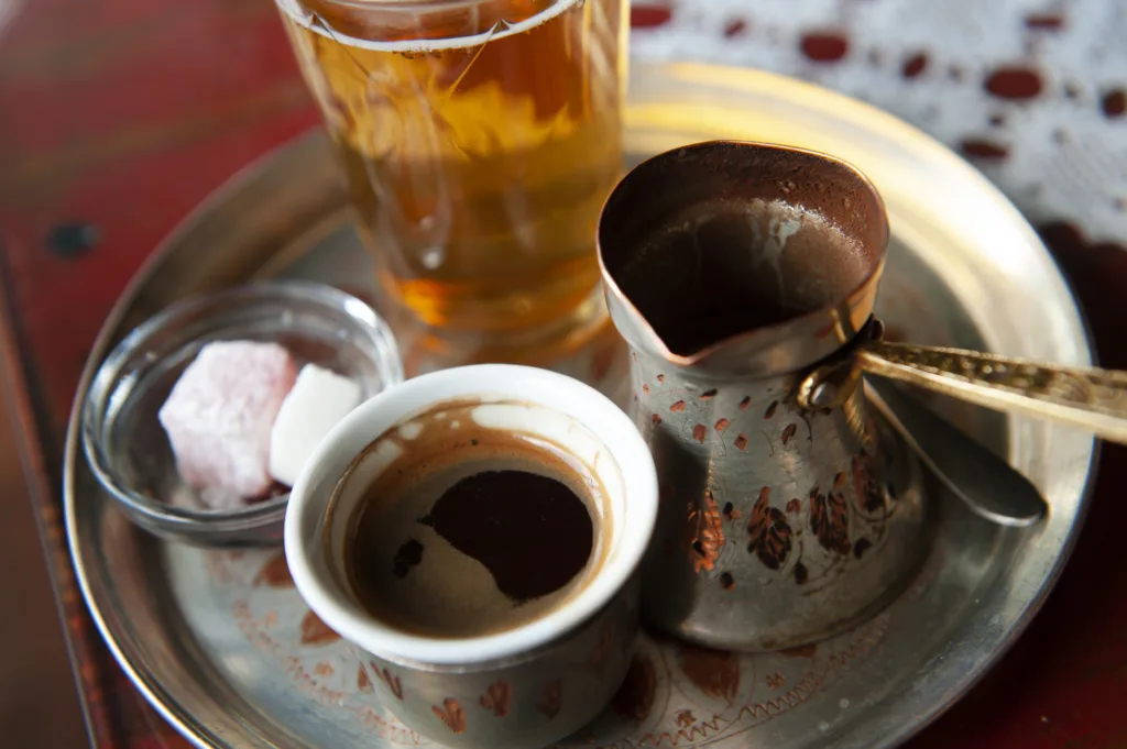 Traditional Bosnian Coffee served from a copper pot with local sweets. Sarajevo, Bosnia and Herzegovina