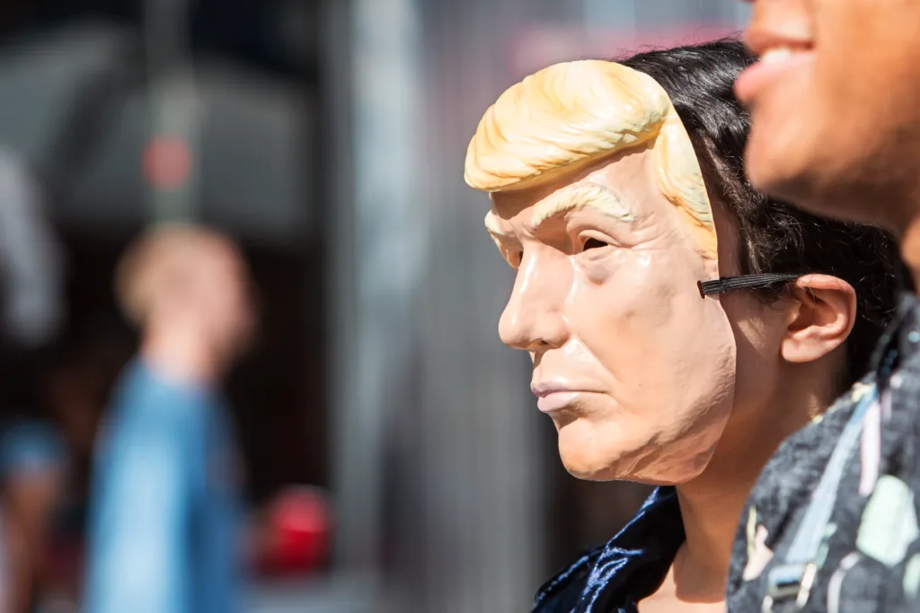 A person wears a Donald Trump mask at the Little Five Points Halloween Parade on October 21, 2017 in Atlanta, GA.