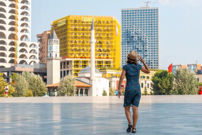 A tourist walking on vacation through Skanderbeg Square in Tirana. Albania