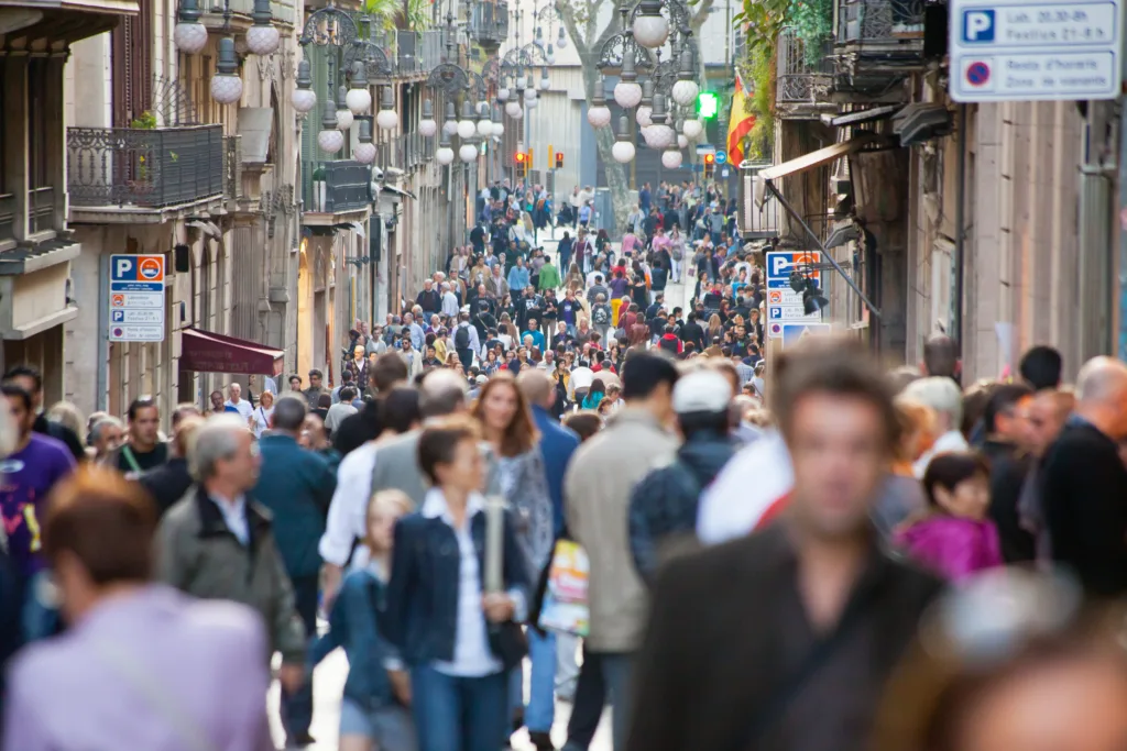 Barcelona, Spain - October 22, 2011: People, many of them tourists, walking down Carrer Ferran, which runs from Plaça Sant Jaume (where the town hall is located) to the popular \"Rambles\" of Barcelona.