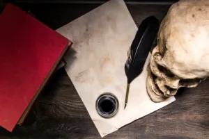 Books, human skull, pen and paper on rustic wood. Literature, writing and language concept