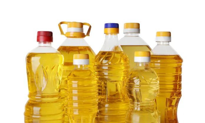 Bottles of cooking oil on white background