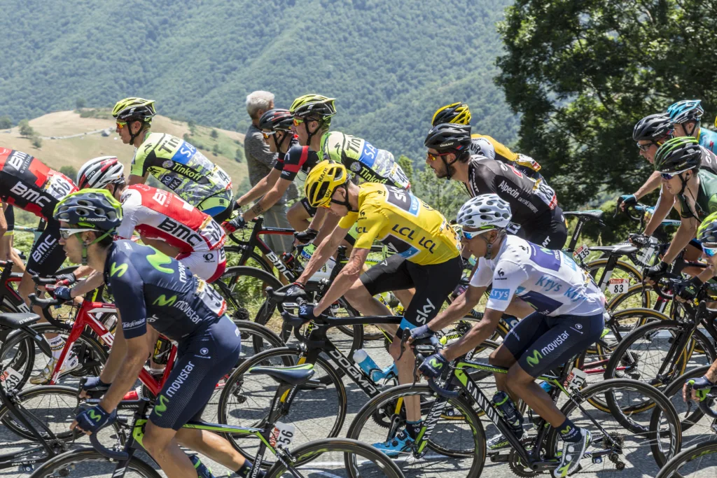 Col D'Aspin,France- July 15,2015: Froome of Team sky, in Yellow Jersey and his main rival Quintana of Movistar Team, in White Jersey, climbing,inside the peloton, the road to Col D'Aspin in Pyrenees Mountains during the stage 11 of Le Tour de France 2015.