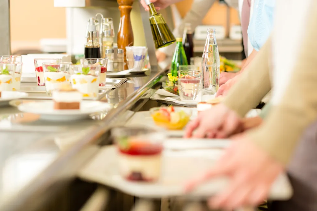 Desserts at cafeteria people with serving tray self service canteen