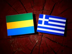 Gabon flag with Greek flag on a tree stump isolated