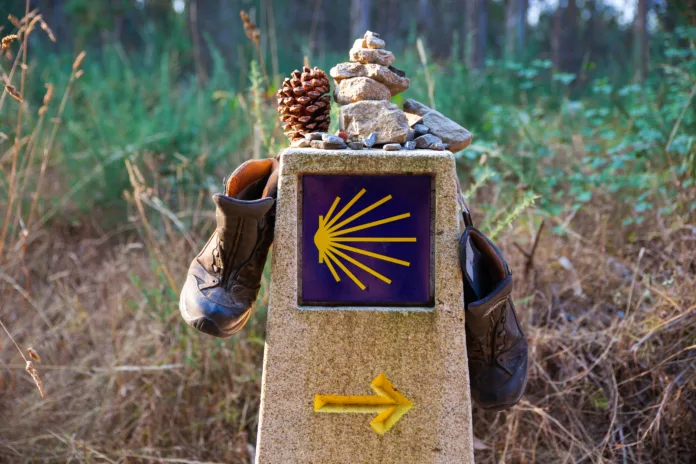 Hiking boots and stone on the stone signal, Symbol of the way of St. James