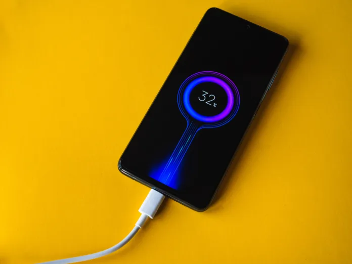 Lleida, Spain. 11/25/2020: Xiaomi POCO X3 new blue smartphone charging 32% battery, developed by Xiaomi Inc. Xiaomi is a privately owned Chinese electronics company.