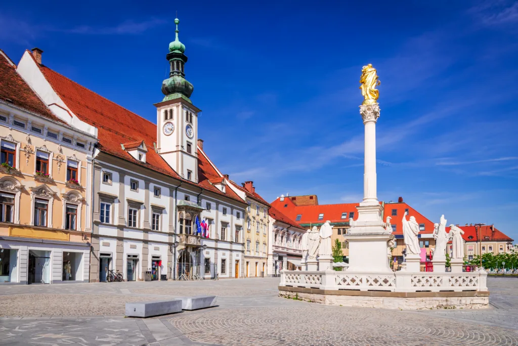 Maribor, Slovenia. Sunny view of Maribor Old, scenic Lower Styria cityscape with Main Square and Plague Column.