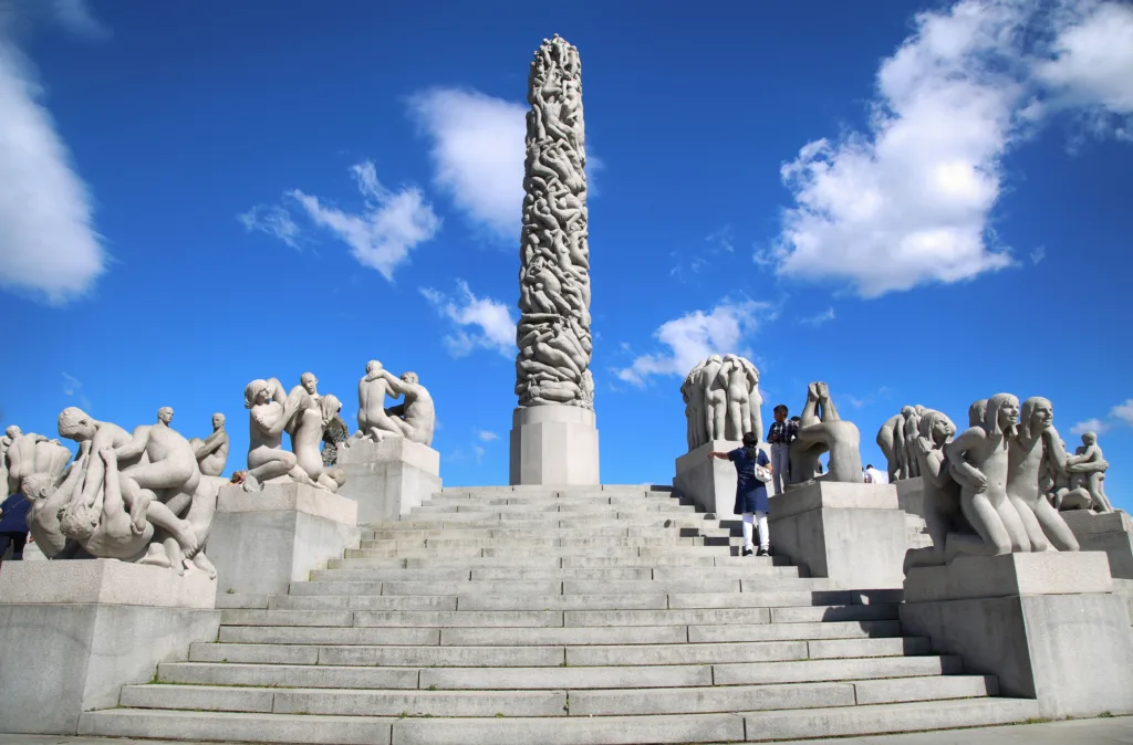 Oslo, Norway - August 18, 2016: Many tourist walk Vigeland Sculptures Park in the popular Vigeland park ( Frogner Park ), designed by Gustav Vigeland in Oslo, Norway