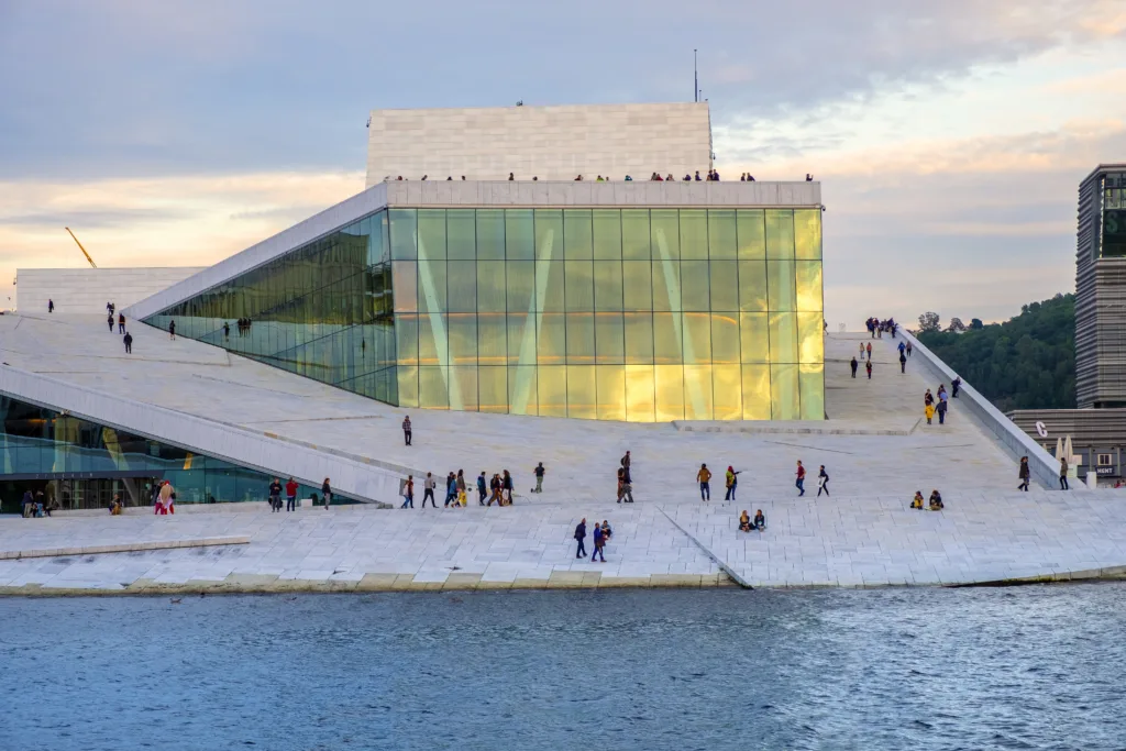 Oslo, Ostlandet / Norway - 2019/08/31: Modernistic Oslo Opera House - Operahuset - at the Bjorvika district at Oslofjord sea waterfront