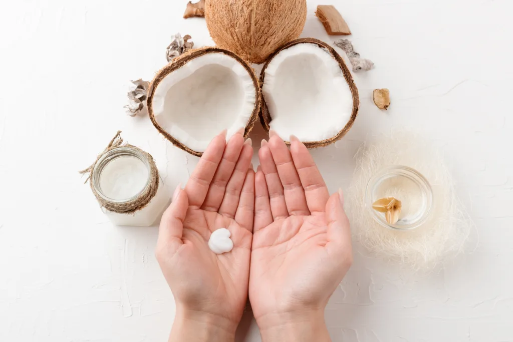 Woman apply the moisturizing cream consist of cocount ingredients to her hands.