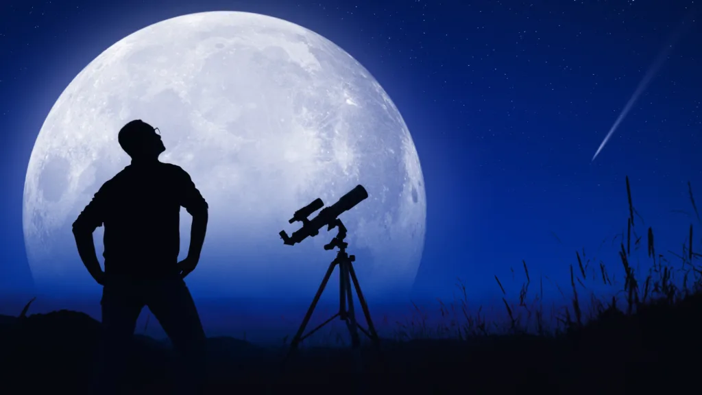 Astronomer looking at the starry skies with a telescope.