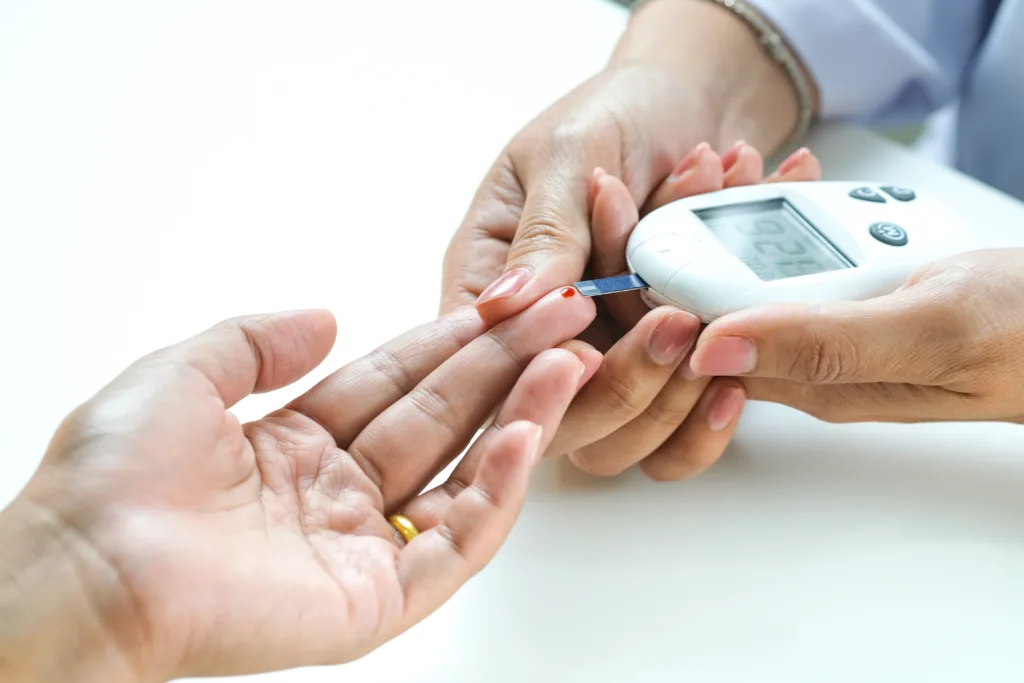 hand of people check diabetes and high blood glucose monitor with digital pressure gauge. Healthcare and Medical concept.