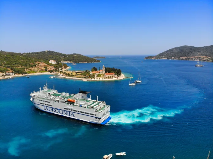 Jadrolinija car ferry approaches Vis island harbor in Croatia.