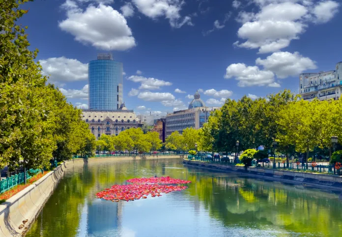 Landscape view of the famous Dambovita River crossing the city Bucharest on a sunny day in Romania