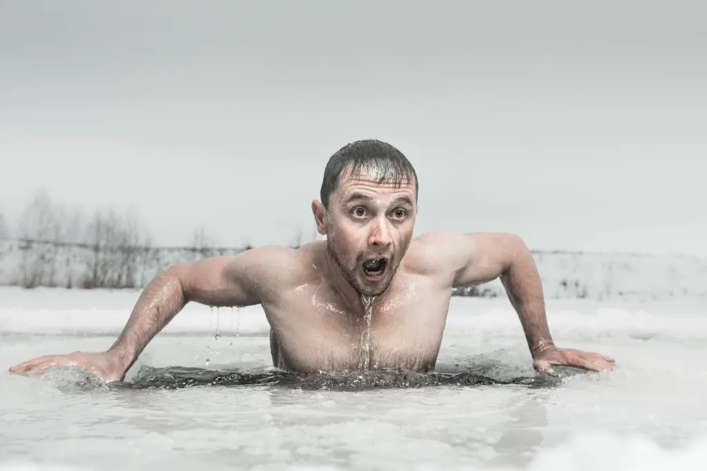 Man swimming in the ice hole with emotional face