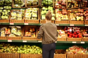 Middle-age woman buying vegetables at the market