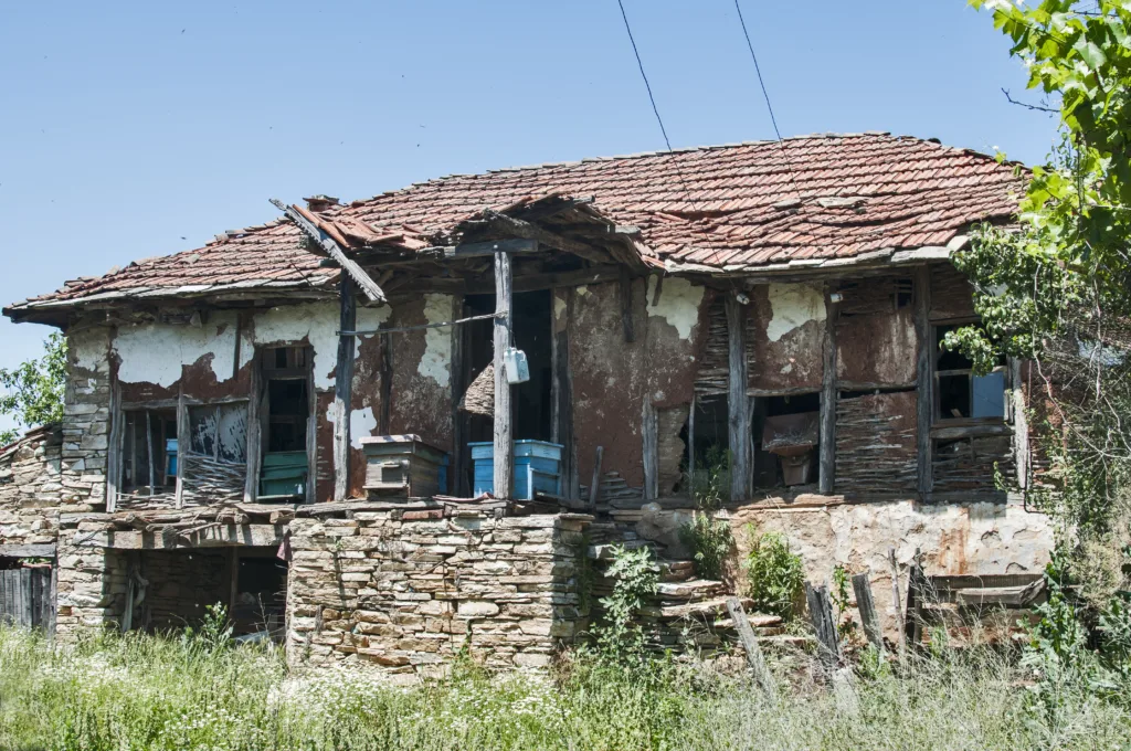 Old rural neglected country house closeup in sunny summer day