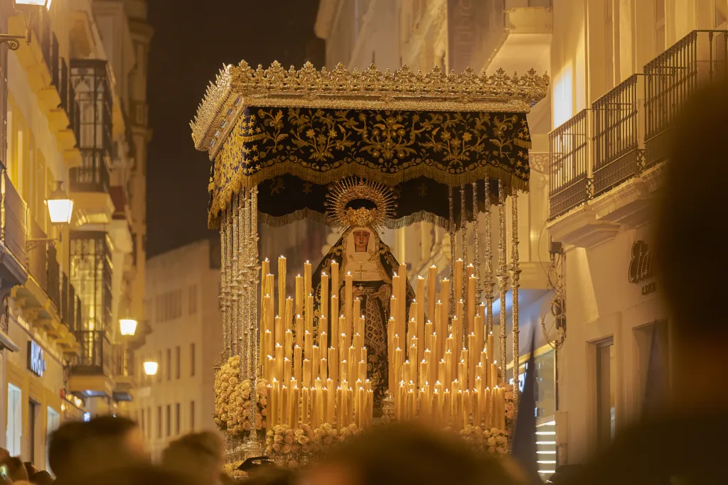 Seville, Spain; 07th April 2023. Brotherhood of Montserrat of Seville. The candles are lit and the paso is surrounded by people. The scene corresponds to a religious or cultural act of Good Friday