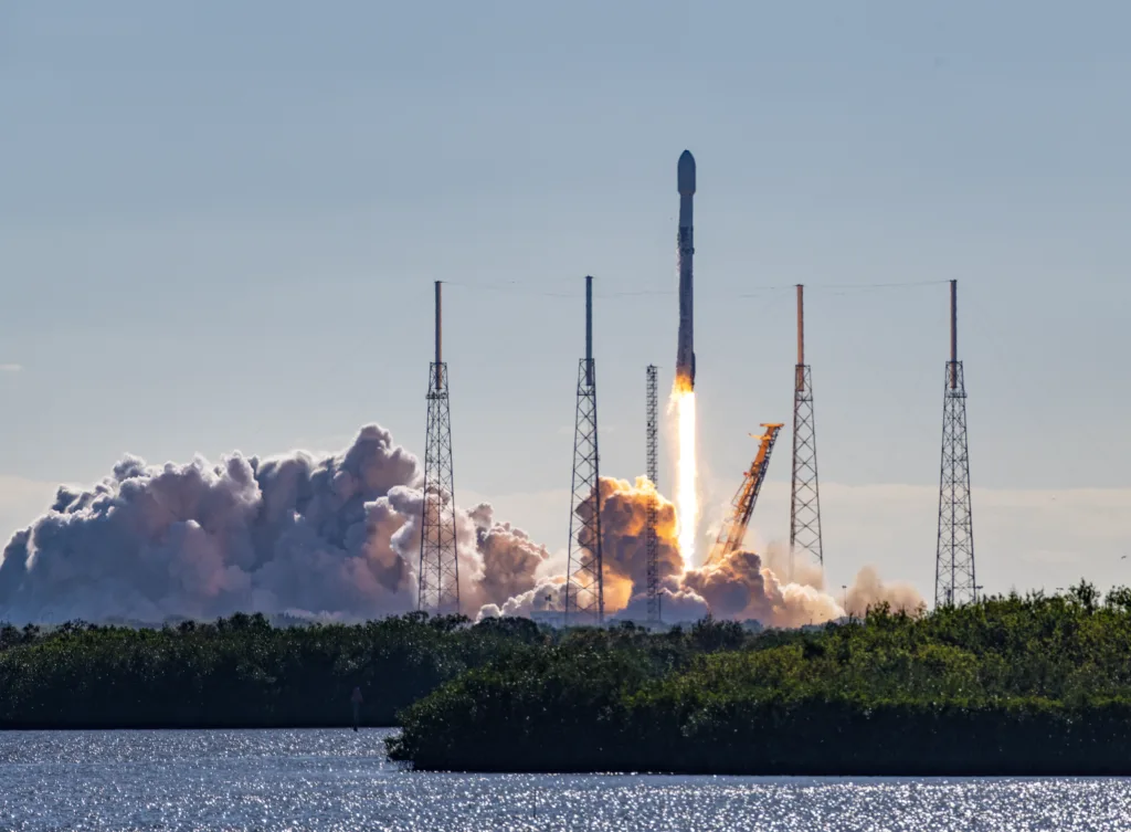 SpaceX Falcon 9 rocket and satellite payload launch in Florida. Booster are re-usable and either land at Cape Canaveral or on a barge at sea. Towers surrounding the launch pad are lightning arrestors. Merritt Island National Wildlife Refuge, Florida, USA
01/03/2023