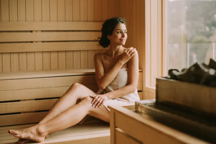 Attractive young woman relaxing in the sauna