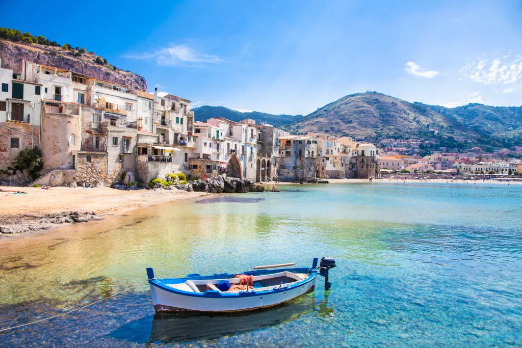 Beautiful old harbor with wooden fishing boat in Cefalu, Sicily, Italy.