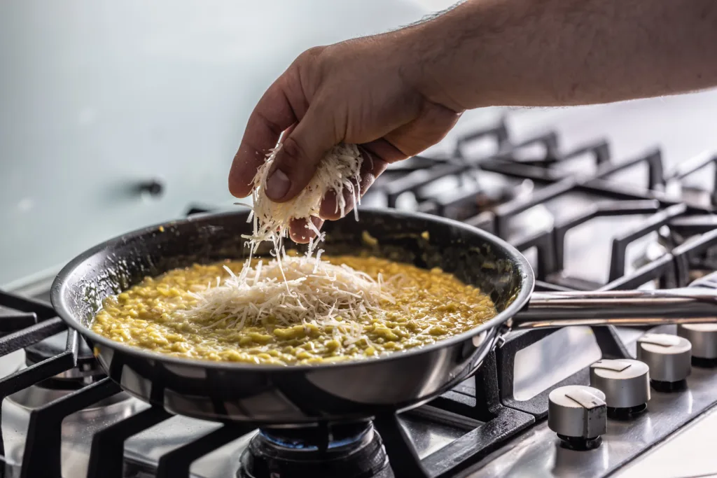 Part of making risotto is adding parmesan cheese at the end.