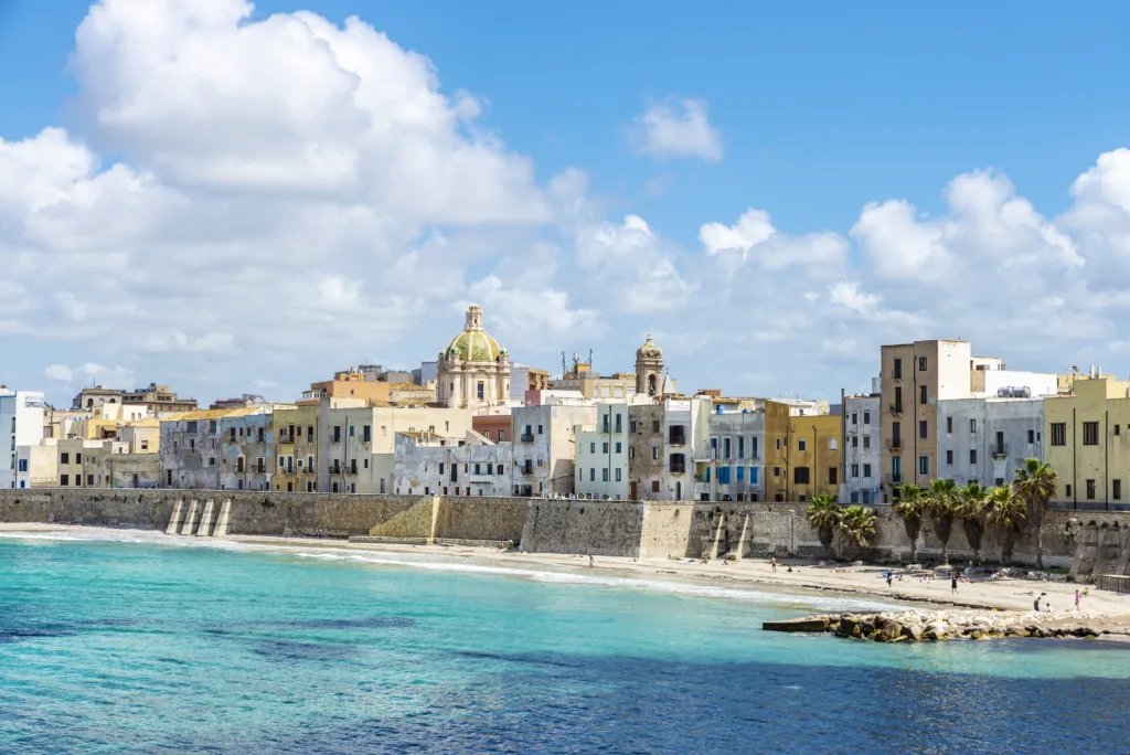 Promenade and beach with people around in the old town of Marsala, Trapani, Sicily, Italy