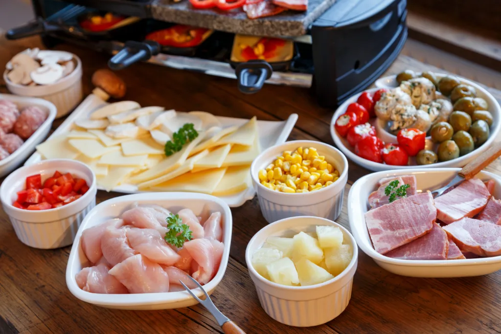 Raclette with vegetables, meat and cheese