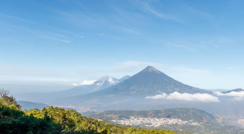 Volcanos agua acatenango and fuego in guatemala during a sunny day seen from pacaya.