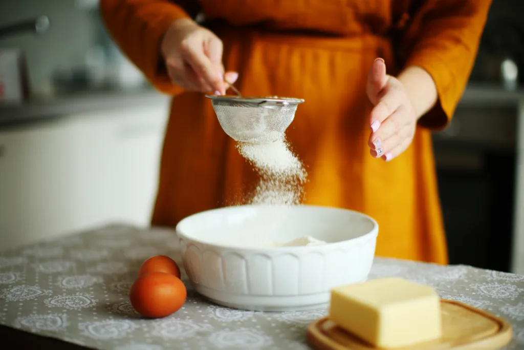 woman hand preparing a dough in a home kitchen