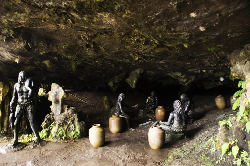 Archaic humans Neanderthal antique statue in stone cave underwater falls of Furong Zhen and Tujia ancient town city for chinese travelers travel visit at Yongshun County on May 9, 2024 in Hunan, China