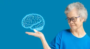 Brain on the palm a senior woman. Dementia in people. Memory loss. Alzheimer's, Parkinson's disease, stroke, seizure, mental health, etc. Aged people and healthcare concept