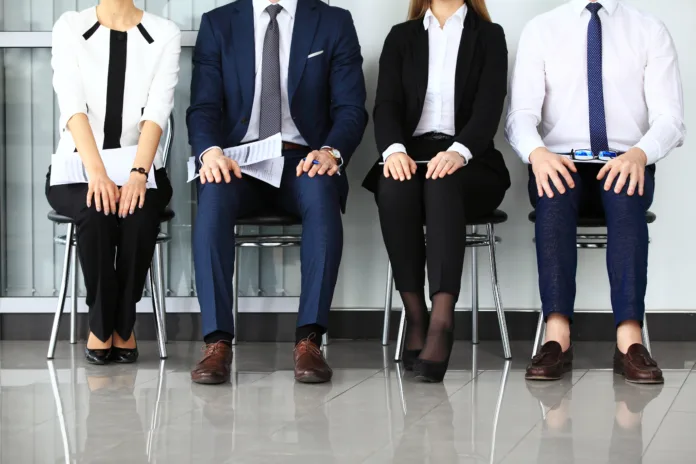 Business people waiting for job interview. Four candidates competing for one position